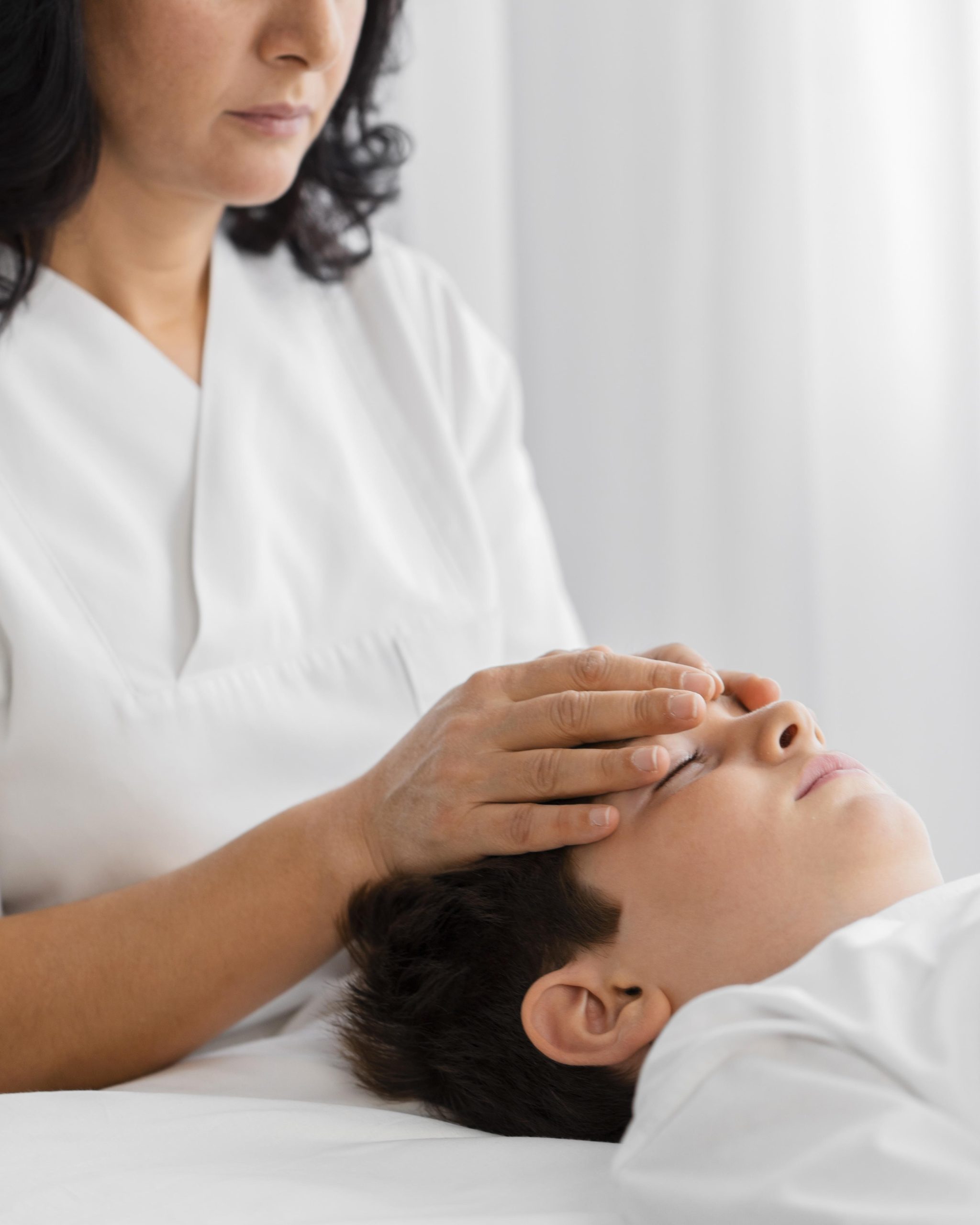 osteopathist-treating-child-by-massaging-his-head