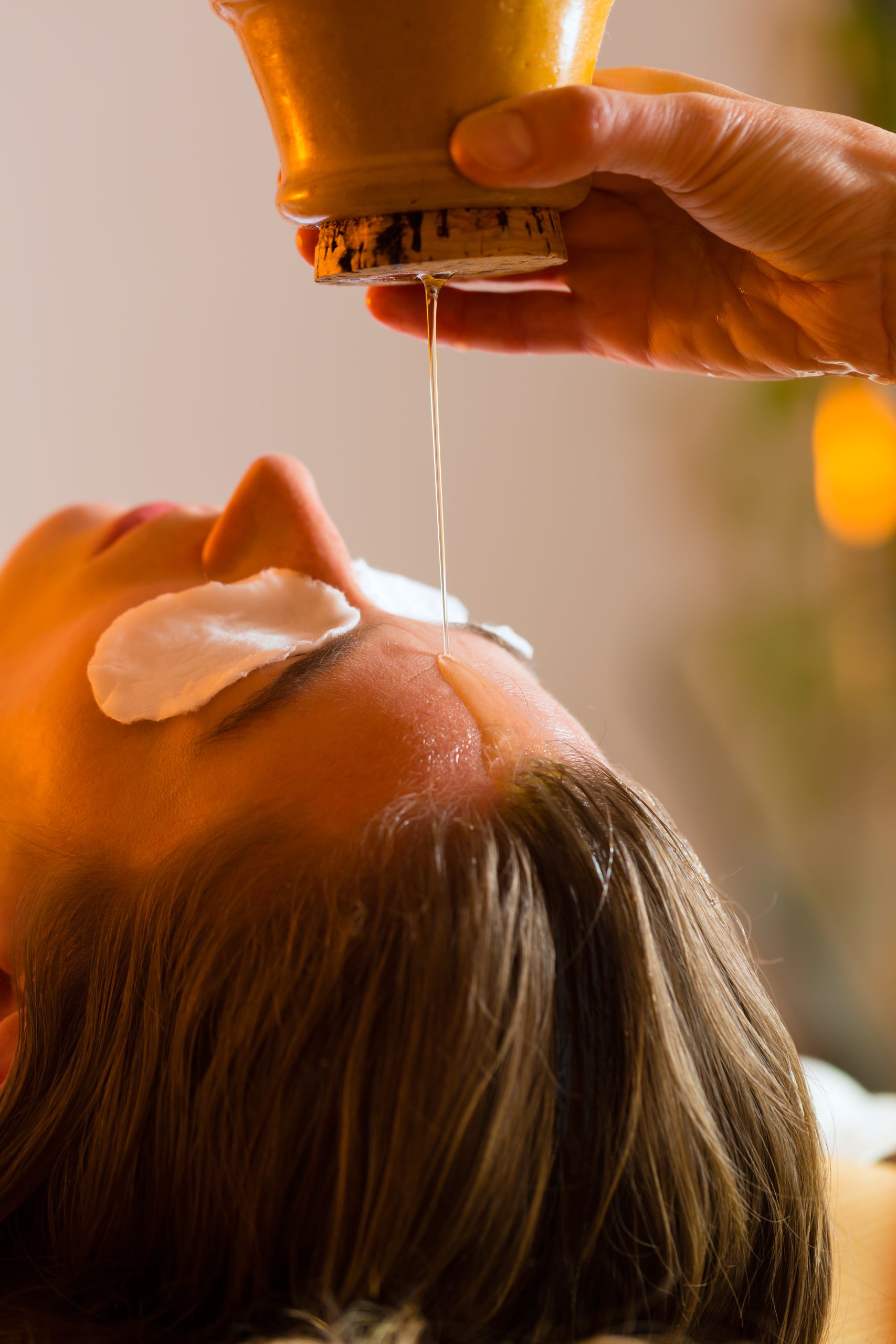 Woman enjoying a Ayurveda oil massage treatment in a spa